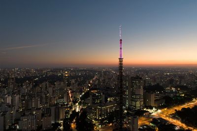 Aerial view of illuminated city buildings against sky