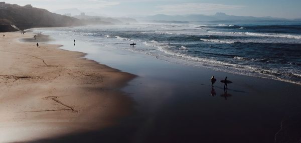 High angle view of silhouette people at beach