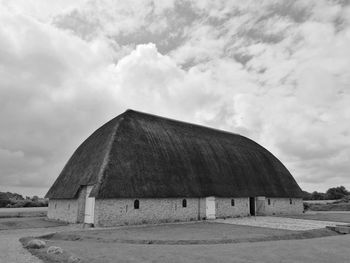 Barn on field against sky