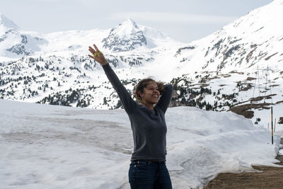 Woman standing on snow covered mountain