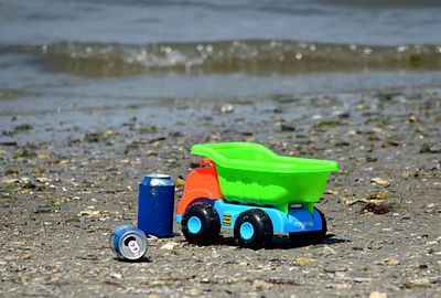 Close-up of toy car on sand at beach