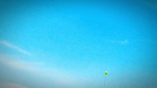 Low angle view of hot air balloon against blue sky