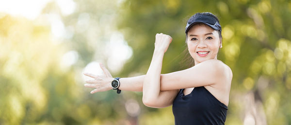 Portrait of a smiling young woman holding outdoors