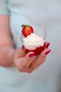 Close-up of hand holding dessert