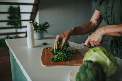 Midsection of man preparing food on table at home