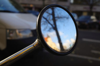 Close-up of eyeglasses on side-view mirror