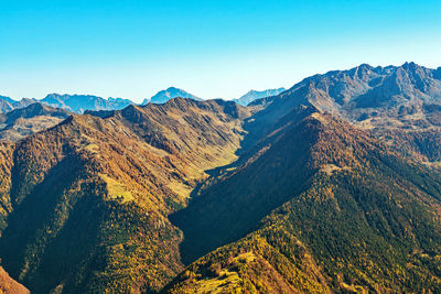 Scenic view of mountains against clear blue sky