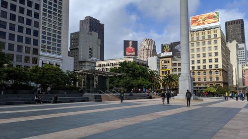 City street by buildings against sky