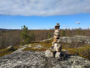 Stack of rocks on land against sky