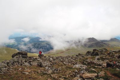 Scenic view of mountains against cloudy sky