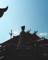 Low angle view of statue against sky