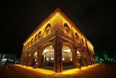 Low angle view of illuminated building at night