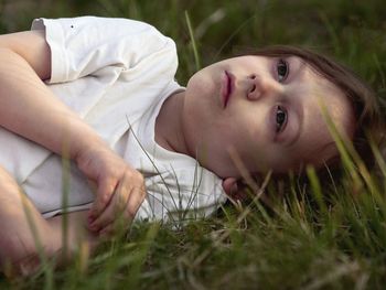 Portrait of woman lying on field