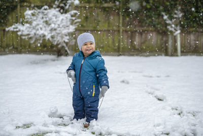 Smiling boy in snow during winter