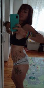 Midsection of woman using mobile phone at home