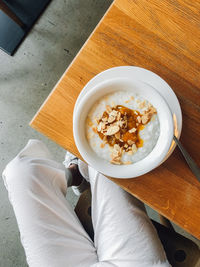 High angle view of breakfast, porridge with compote, on table in restaurant.