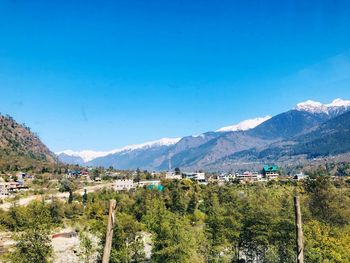 Scenic view of mountains against clear blue sky