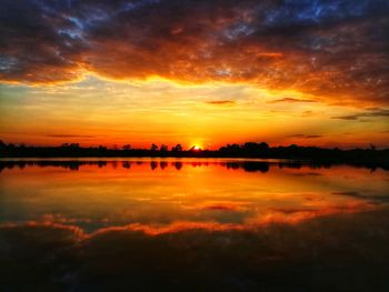 Scenic view of lake against romantic sky at sunset