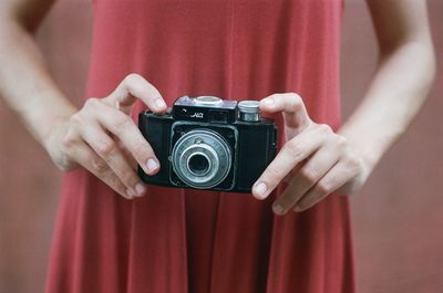 Midsection of person holding camera