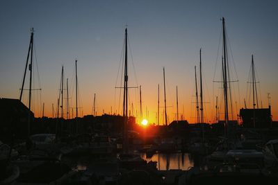Boats in harbor at sunset