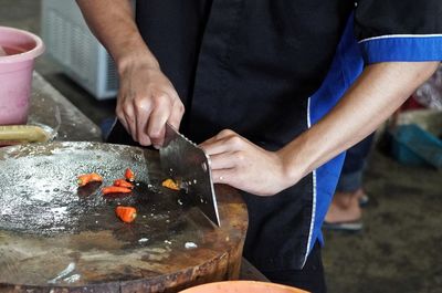 Midsection of man preparing food