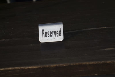 Close-up of information sign on table