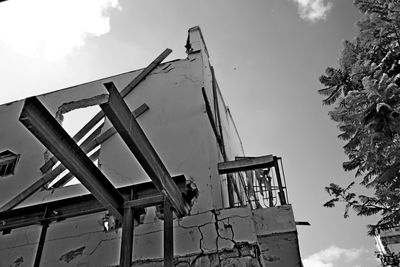 Low angle view of old construction site against sky