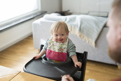 Portrait of cute baby boy sitting on table