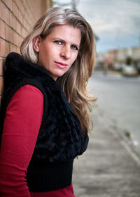 Portrait of beautiful young woman standing outdoors