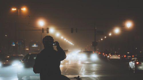 Man using mobile phone at night