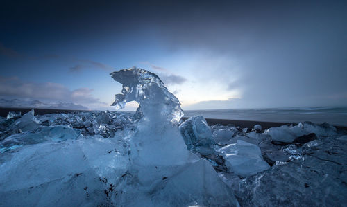 Scenic view of frozen sea against sky during winter