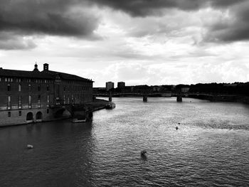 View of bridge over river against cloudy sky