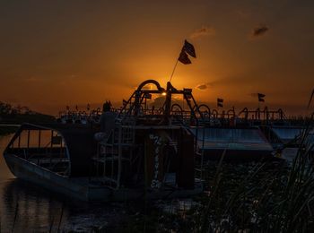 Hovercrafts in river against orange sky