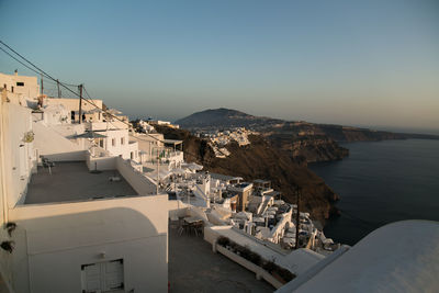 High angle view of town by sea against clear sky