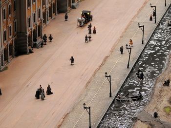 High angle view of people walking on road in city