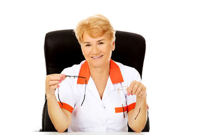 Portrait of a smiling woman against white background