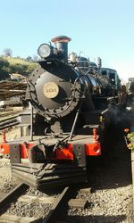 Train on railroad tracks against clear sky