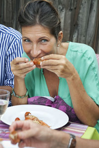 Mature woman eating at crayfish party, sweden