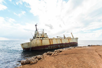 View of ship on beach against sky