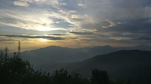 Scenic view of silhouette mountains against sky at sunset