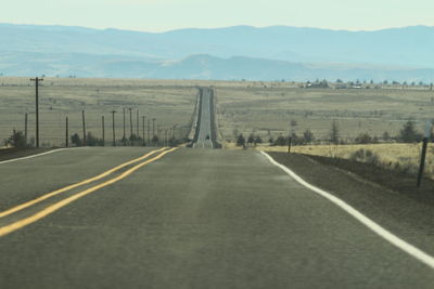 Road amidst landscape against sky