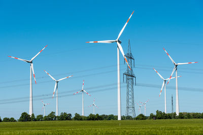 Power supply lines and wind turbines seen in rural germany