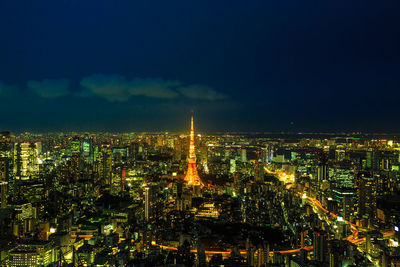 High angle view of city lit up at night