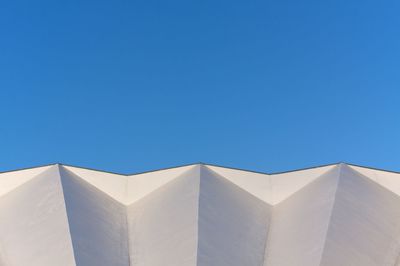 Low angle view of built structure against clear blue sky