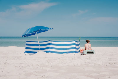 Scenic view of beach against blue sky