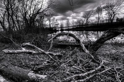 Bridge over river against cloudy sky