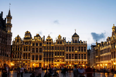 Group of people in front of buildings in city