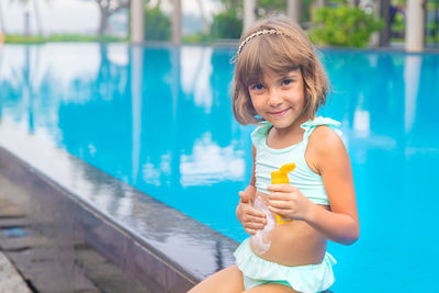 Portrait of smiling girl playing in swimming pool