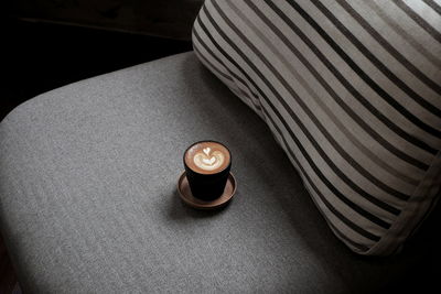 High angle view of cappuccino on chair