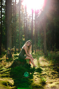 Young woman sitting in forest